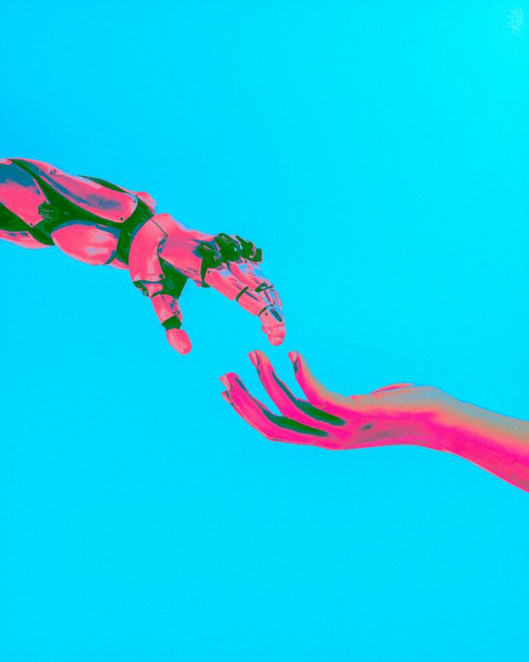 A hand reaching out towards a robot hand